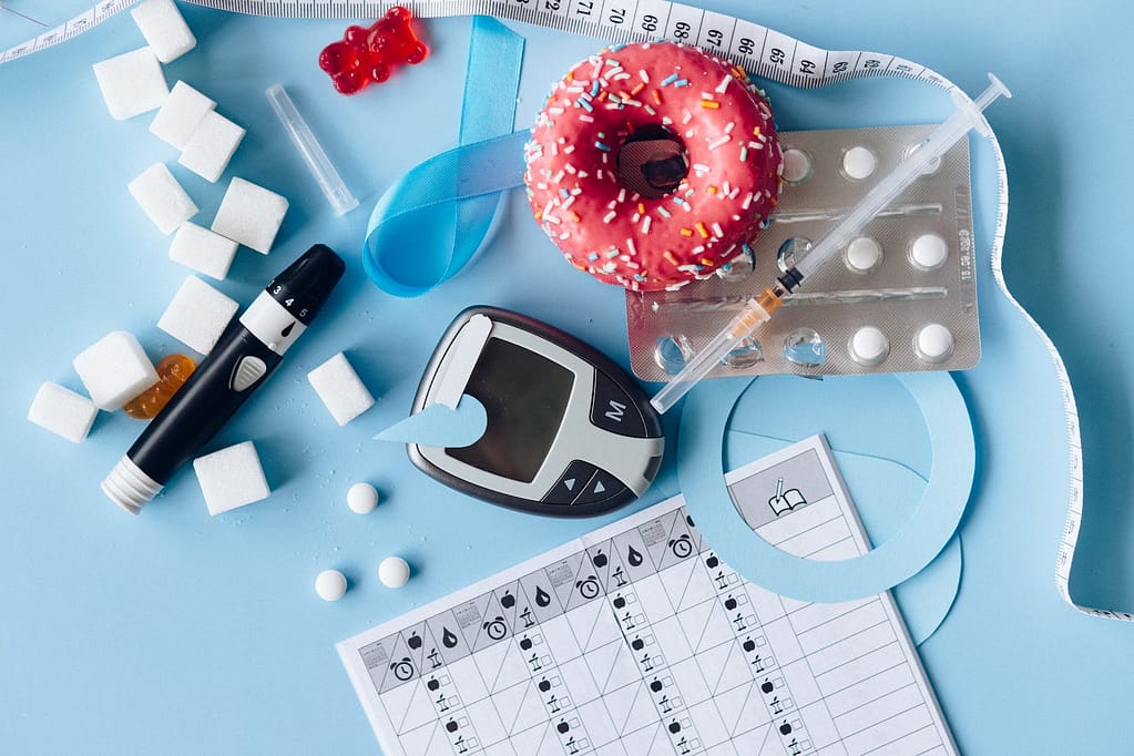 blood sugar meter and medication on the blue background